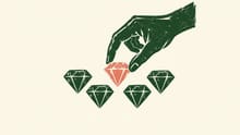 Taste A hand selecting one salmon-coloured diamond from a group of green diamonds